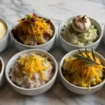 Eight types of holiday mashed potato Magic in white bowls – creamy, cheesy, loaded, Cajun, garlic, and gravy-topped side dishes on marble surface.Classic Creamy Mashed Potatoes.Loaded Ranch Mashed Potatoes.Garlic Parmesan Mashed Potatoes.Spicy Cajun Mashed Potatoes.Cheddar & Sour Cream Mashed Potatoes.Corn & Cheddar Mashed Potatoes.Four-Cheese Mashed Potatoes.Gravy Mashed Potatoe