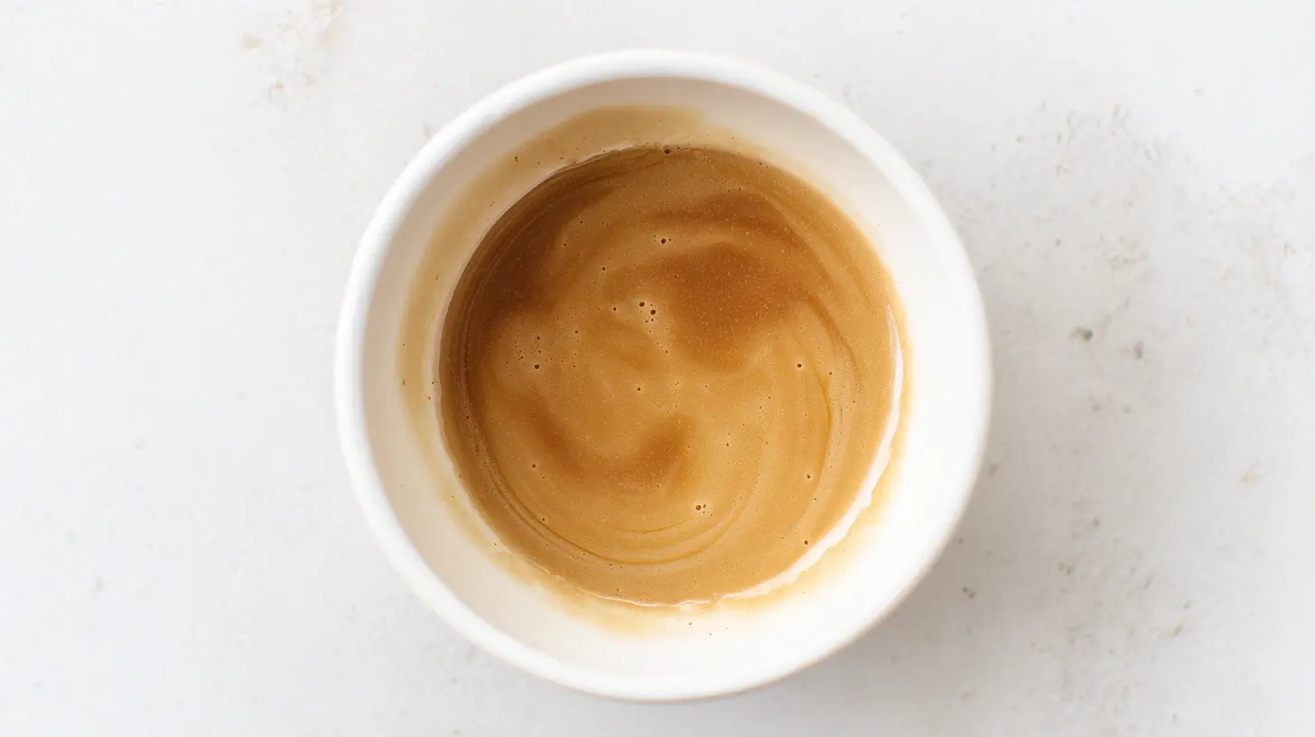 Brown butter cinnamon glaze in a white bowl – glossy cinnamon dessert sauce made with browned butter, perfect for cookies, cakes, and fall baking recipes