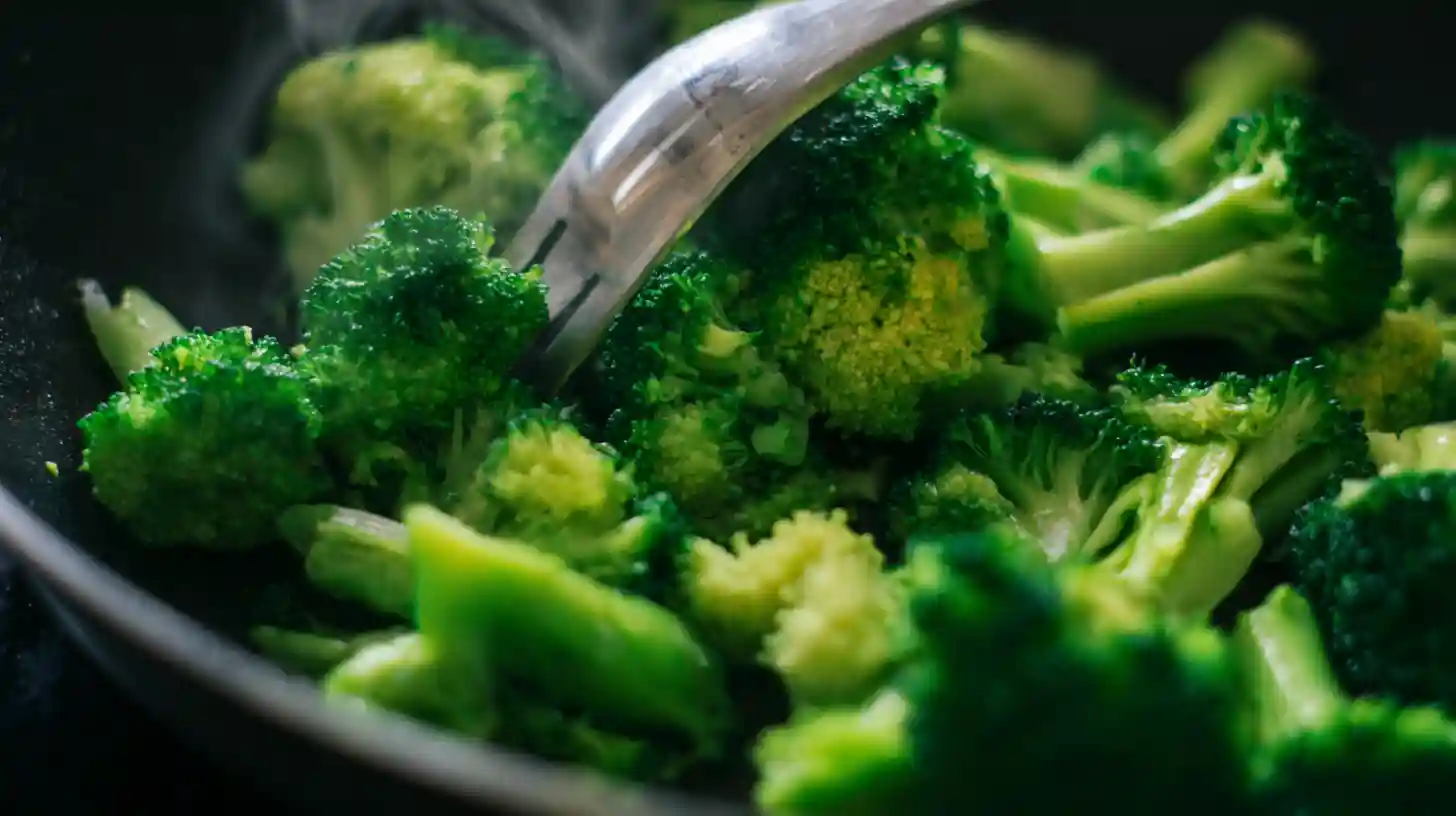 Bright green broccoli florets sautéing in skillet — how to cook broccoli for healthy vegetable side and easy skillet meals