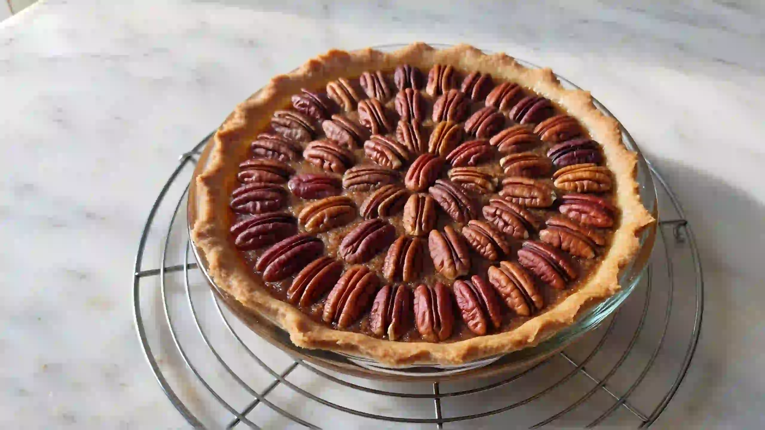 Condensed milk pecan pie cooling on wire rack for clean slicing – homemade holiday dessert with buttery crust and toasted pecans