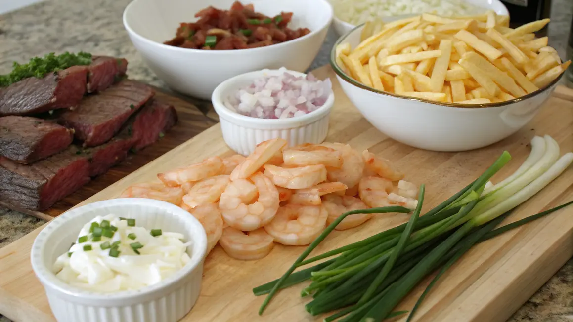 Ingredients for Loaded Steak and Shrimp Cheese Fries including sliced steak, shrimp, French fries, shredded cheese, diced onions, bacon, and green onions.